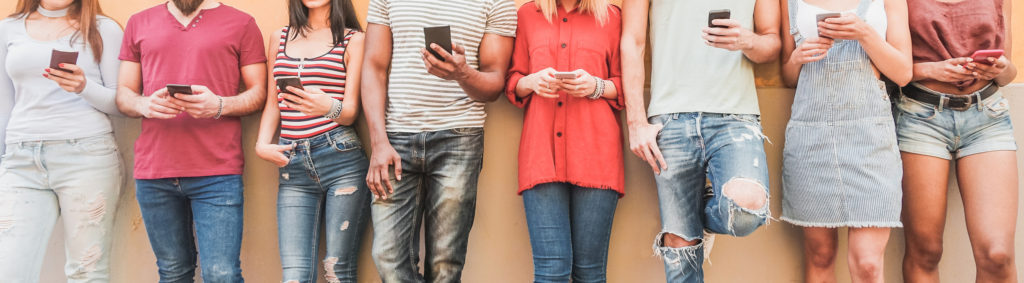 Teenager friends watching videos on smartphones - Millennials generation addiction to new technology trends - Concept of youth, commute, tech, social and friendship - Main focus on center hands